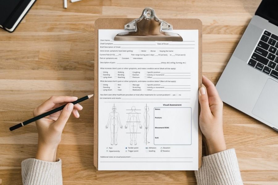 Massage Client Assessment Form on Clipboard