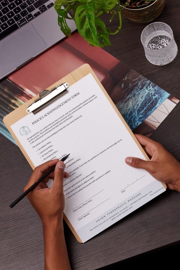 Massage policies Acknowledgement Form on clipboard